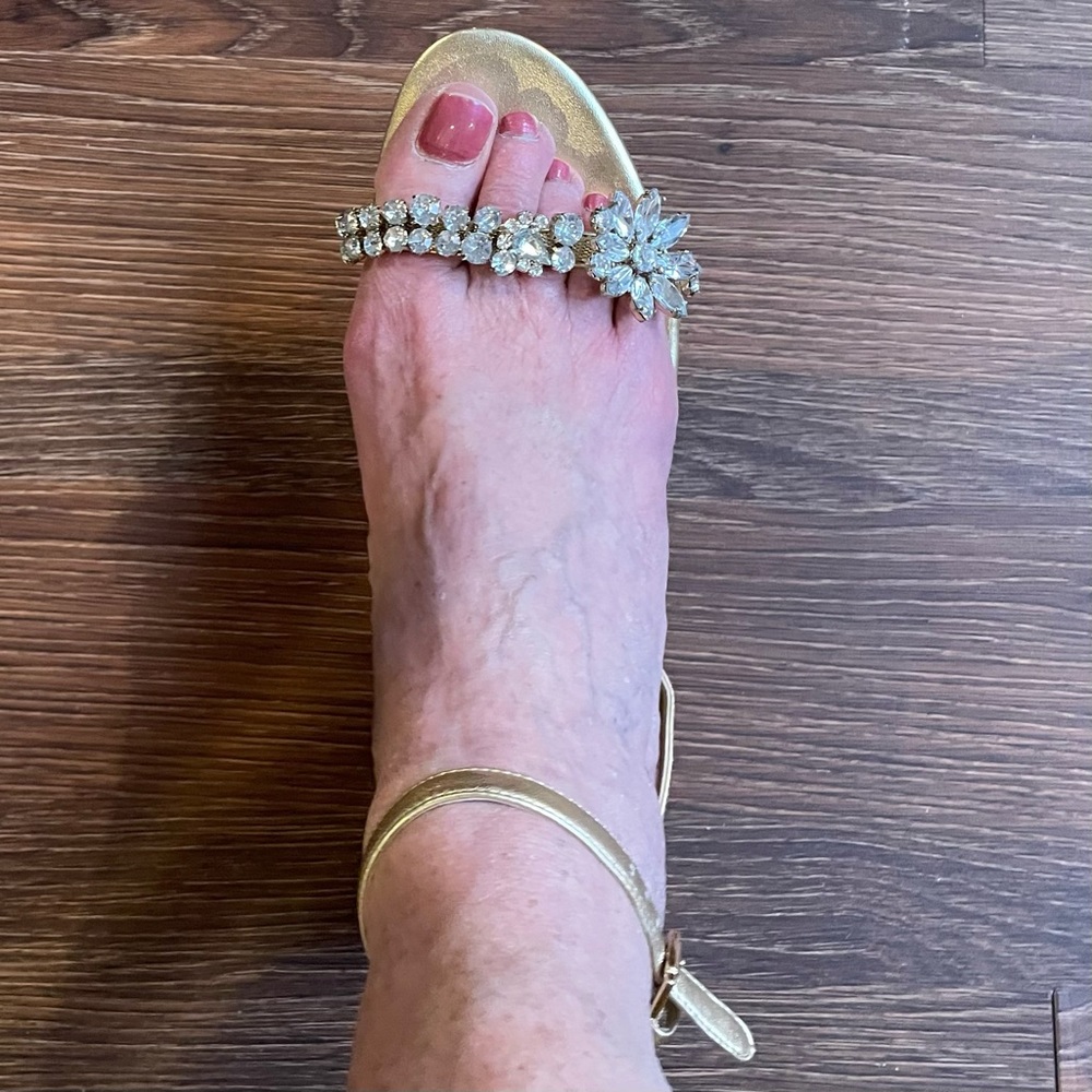 Nine West gold sandals with rhinestone embellishment.